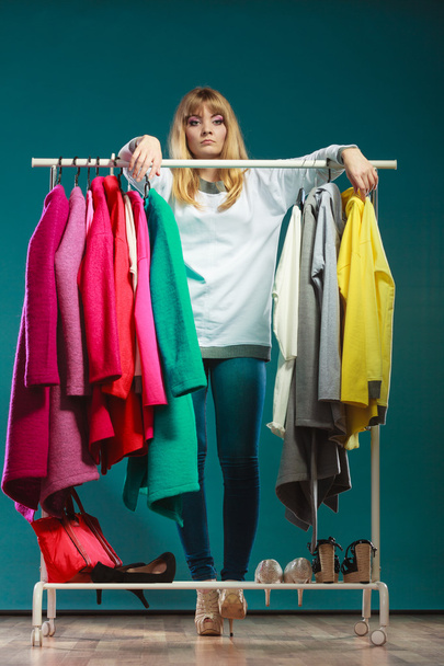 Woman choosing clothes to wear in mall or wardrobe - Fotografie, Obrázek