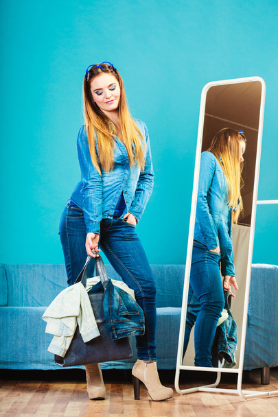 Fashion woman wearing blue denim in front of mirror - Фото, изображение