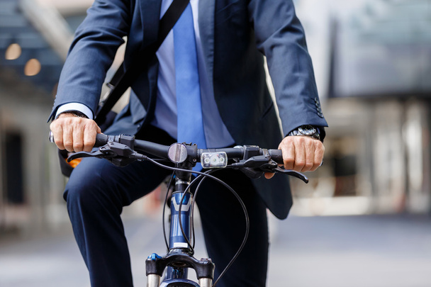 Successful businessman riding bicycle - Photo, Image