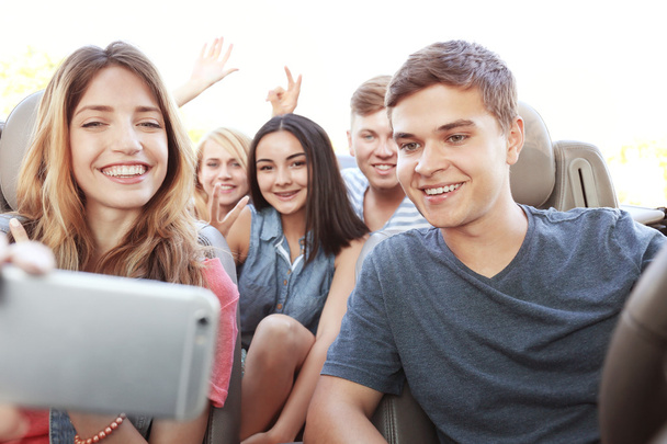 Happy friends taking selfie in car - Фото, изображение