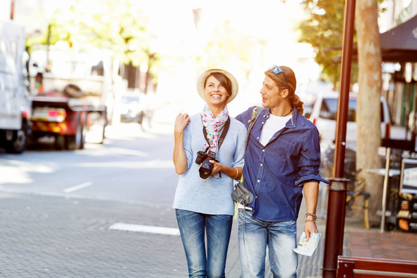 Girl and guy on the streets of a city - 写真・画像