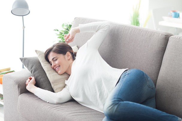 Woman stretching on the couch - Foto, Bild
