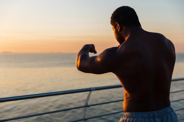 Silhouette of african man athlete boxing outdoors at sunrise - Фото, изображение
