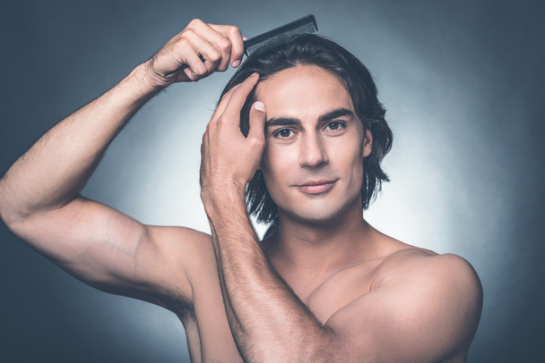 shirtless man combing his hair - Photo, Image
