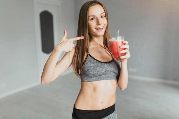 young girl with detox drink after workout - Фото, изображение