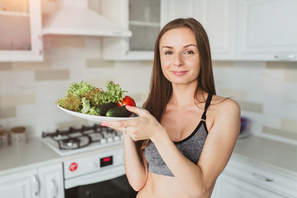 young girl with salad after workout - Photo, Image
