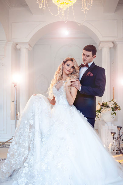 Beautiful young couple, the bride and groom. Luxurious light interior - Fotoğraf, Görsel