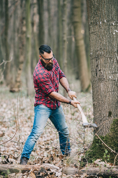 Bearded lumberjack in the woods - Fotó, kép