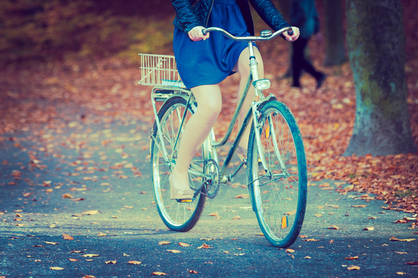 Girl in dress on bike. - Zdjęcie, obraz