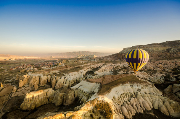 Hot air balloon flying over volcanic rock landscape, Turkey - Photo, Image