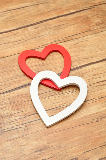 Valentine's Day. A white and red wooden hearts - 写真・画像
