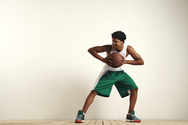 player holding a vintage brown basketbal - Φωτογραφία, εικόνα