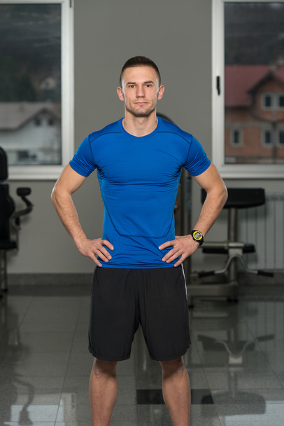 Handsome Personal Trainer Wearing Sportswear In Fitness Center - Foto, afbeelding