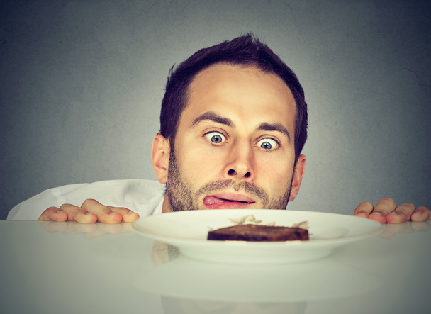 Hungry man craving sweet food  - Фото, изображение