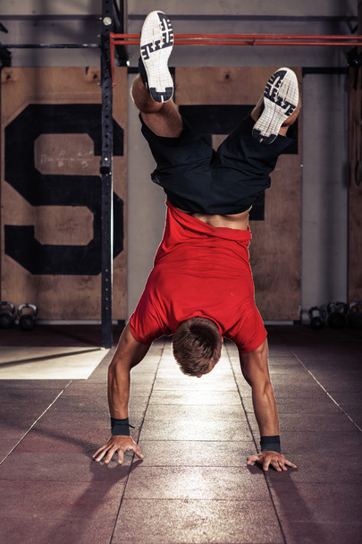 Athlete walking on his hands standing upside down - Photo, Image