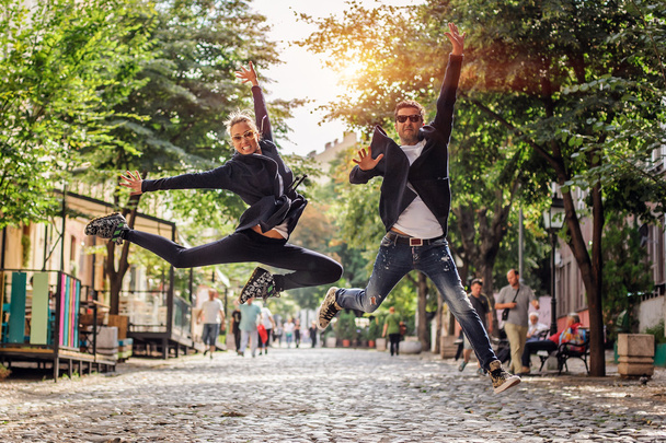 Attractive woman and handsome man jumping on the street - Φωτογραφία, εικόνα