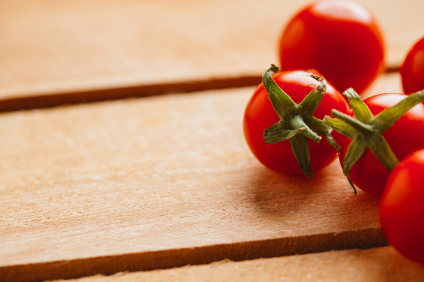Fresh cherry tomatoes on wooden background close up - 写真・画像