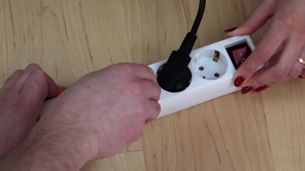 woman and man hands plug wires to electricity extension switch and turn it on. - Footage, Video