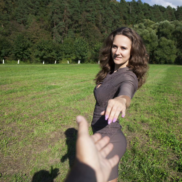 Follow me, Beautiful young woman holds the hand of a man  - Fotoğraf, Görsel