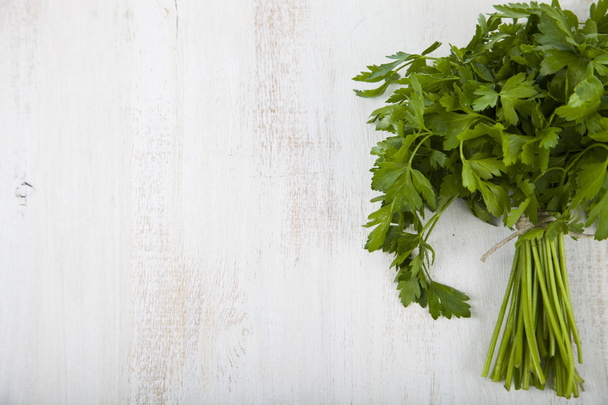 Parsley on a  wooden background - Foto, Imagen
