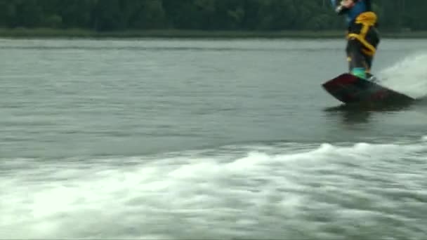 Young man hanging out on a wakeboard sport boat in the summer - Video