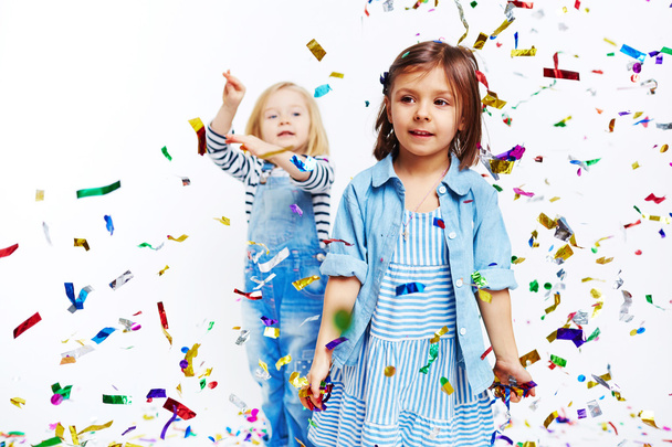 Lttle girls playing with confetti - 写真・画像
