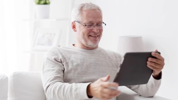 senior man having video call on tablet pc at home 86 - Filmati, video