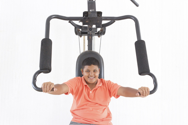 Boy lifting weights - Фото, изображение