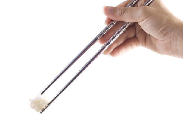 Hand with chopstick holding a rice - Foto, imagen