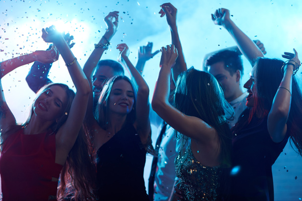 Young people dancing in confetti - Foto, imagen