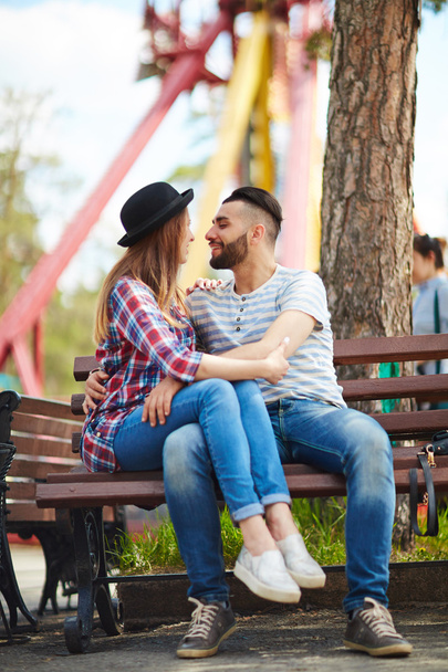 Young couple sitting on bench  - Photo, Image