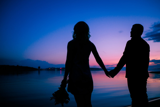 Rendezvous of lovers at sunset (silhouette) - Photo, Image