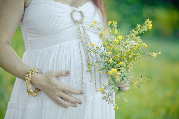 pregnant woman touching stomach close up - Foto, Bild