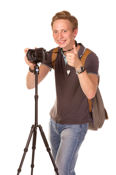 Young man with camera on tripod - Photo, image