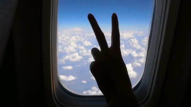 Hand girl shows gesture ok in an airplane. HD - Footage, Video