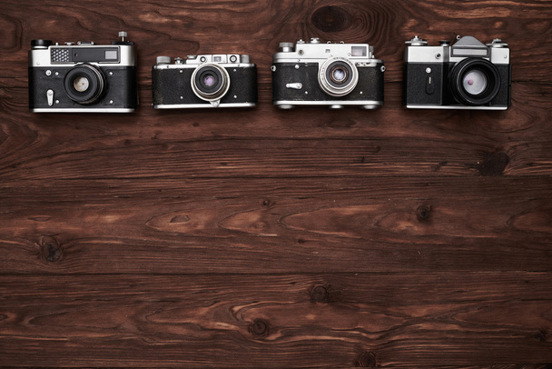 A set of four old-fashioned cameras with a copy space - Photo, Image