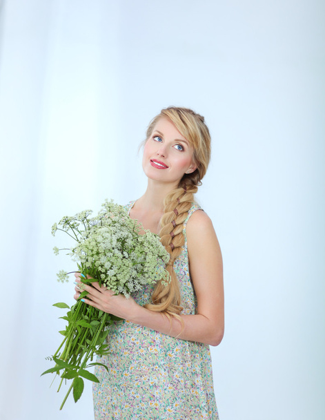 Happy woman stand in white with flowers, isolated on white - Fotografie, Obrázek
