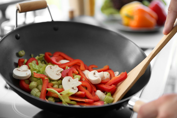 Mixing vegetables in pan - Фото, изображение