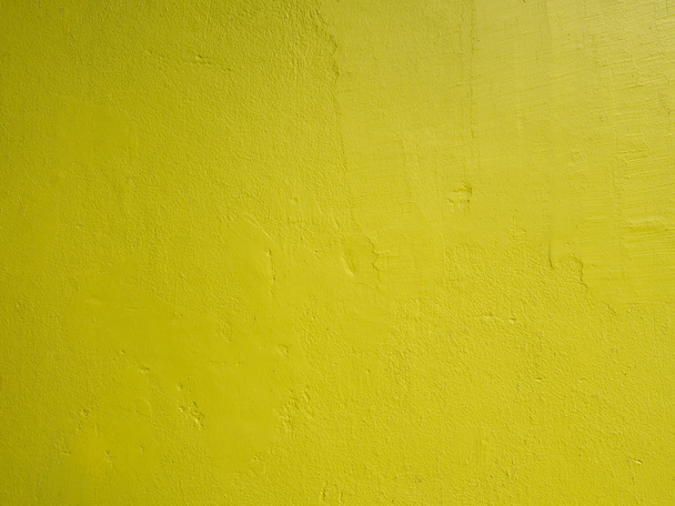 Closeup on abstract vintage grunge texture of yellow cement wall for background or layout design - Foto, immagini
