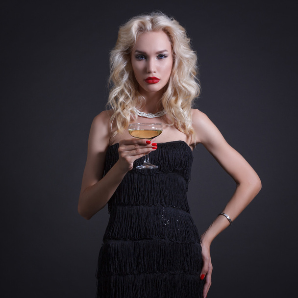 Luxury young woman with glass of champagne. - Foto, afbeelding