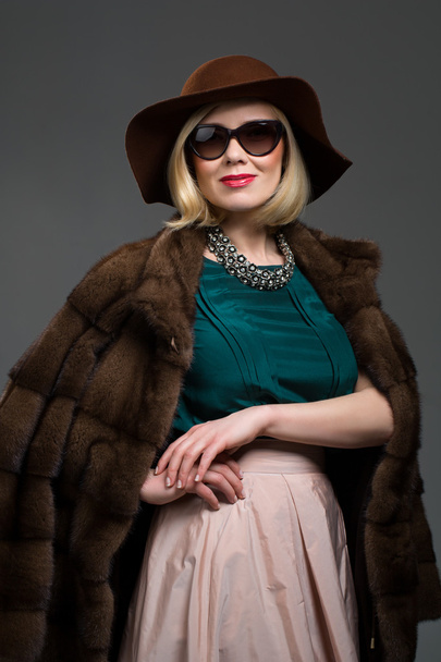 Beautiful mature woman in natural fur coat - Valokuva, kuva