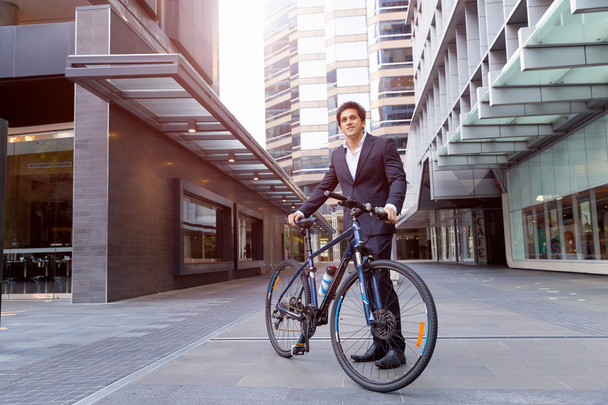 Successful businessman with bicycle - Foto, Imagen