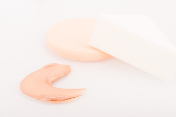 Liquid tinted make-up cream foundation sample stroke and sponges - 写真・画像