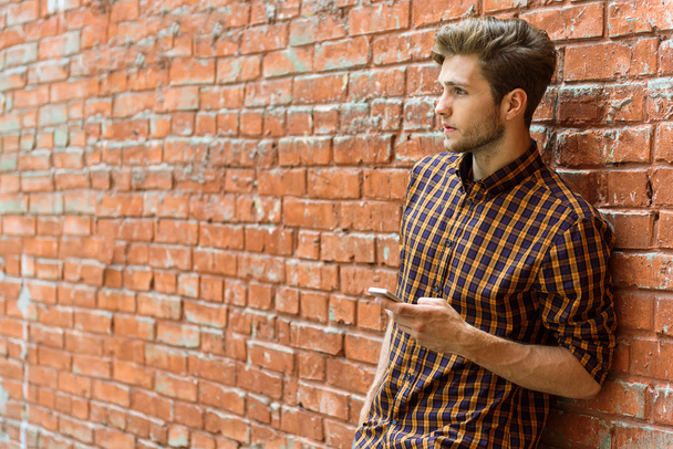 Thoughtful guy messaging on smartphone - 写真・画像