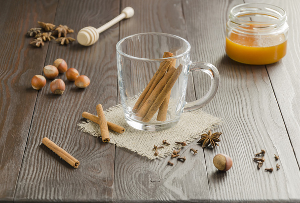 Glass cup with cinnamon sticks - Photo, Image