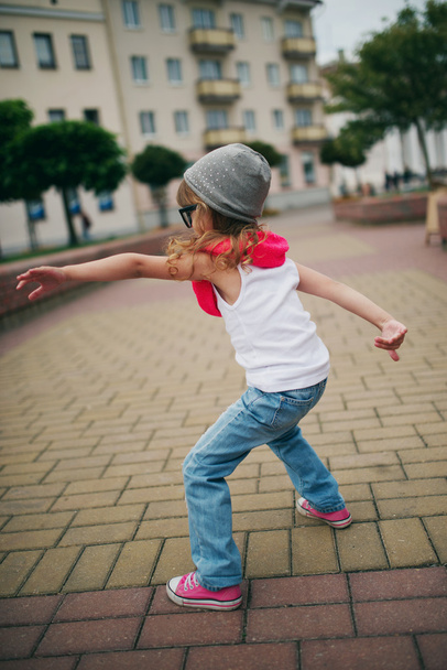 little girl dancing on the street - 写真・画像