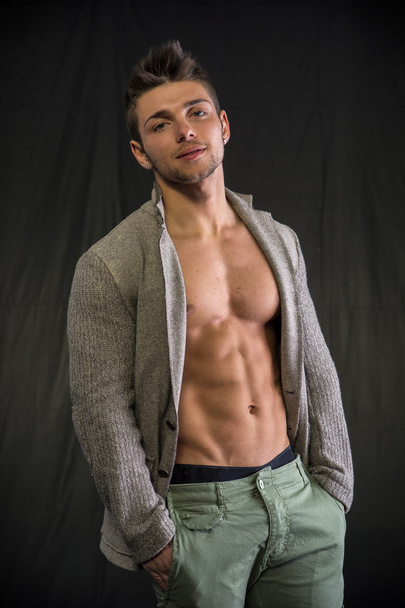 Young man with open jacket on muscular torso - Fotoğraf, Görsel