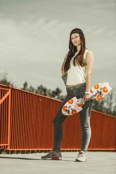 Teenage girl skater riding skateboard on street. - Foto, Imagem