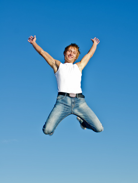 青い空を背景に幸せなジャンプ男 - 写真・画像