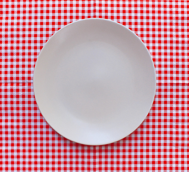 the plate on checkered tablecloth - Photo, Image